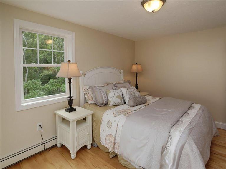 537 Scraggy Neck Road Cataumet, MA 02534 - Photo 21 of 33 a bedroom with a bed and a window
