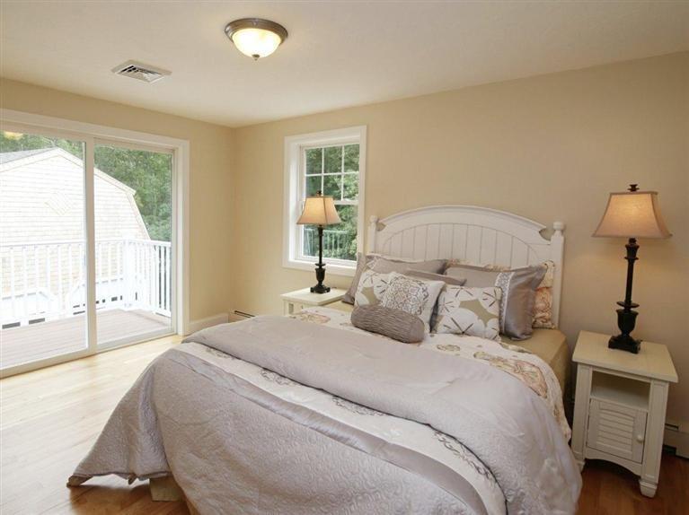 537 Scraggy Neck Road Cataumet, MA 02534 - Photo 22 of 33 a bedroom with a large bed and a large window