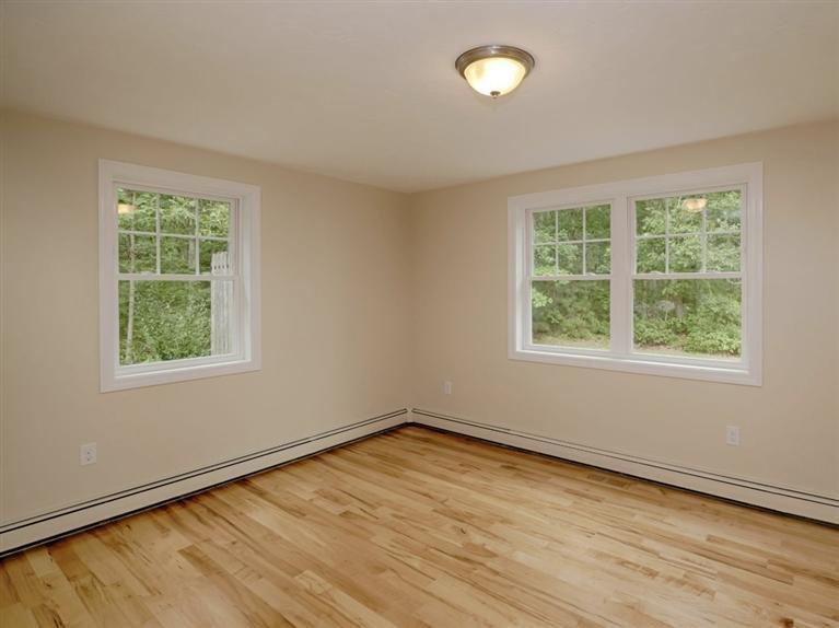 537 Scraggy Neck Road Cataumet, MA 02534 - Photo 24 of 33 an empty room with wooden floor and windows