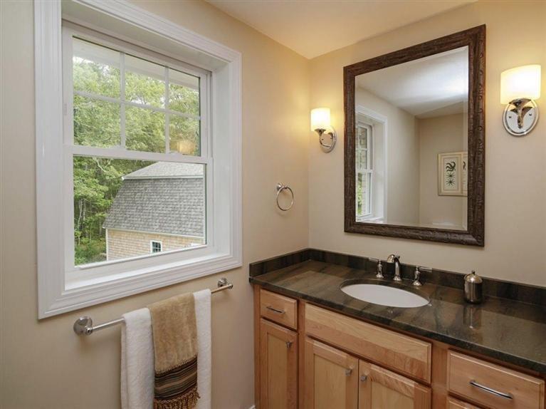 537 Scraggy Neck Road Cataumet, MA 02534 - Photo 25 of 33 a bathroom with a granite countertop sink and a mirror