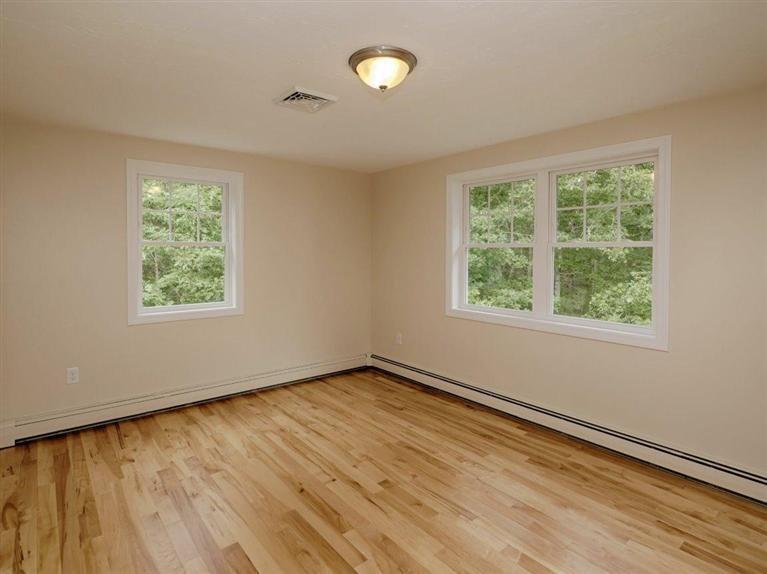 537 Scraggy Neck Road Cataumet, MA 02534 - Photo 27 of 33 a view of an empty room with wooden floor and a window
