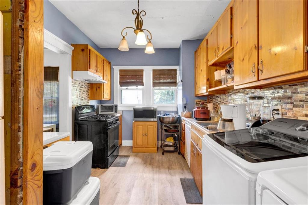 943 Washington Place Southwest Atlanta, GA 30314 - Photo 11 of 25 a kitchen that has a sink stainless steel appliances a counter space and a window