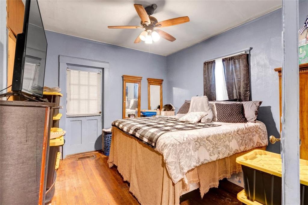 943 Washington Place Southwest Atlanta, GA 30314 - Photo 6 of 25 a bedroom with a bed and a chandelier