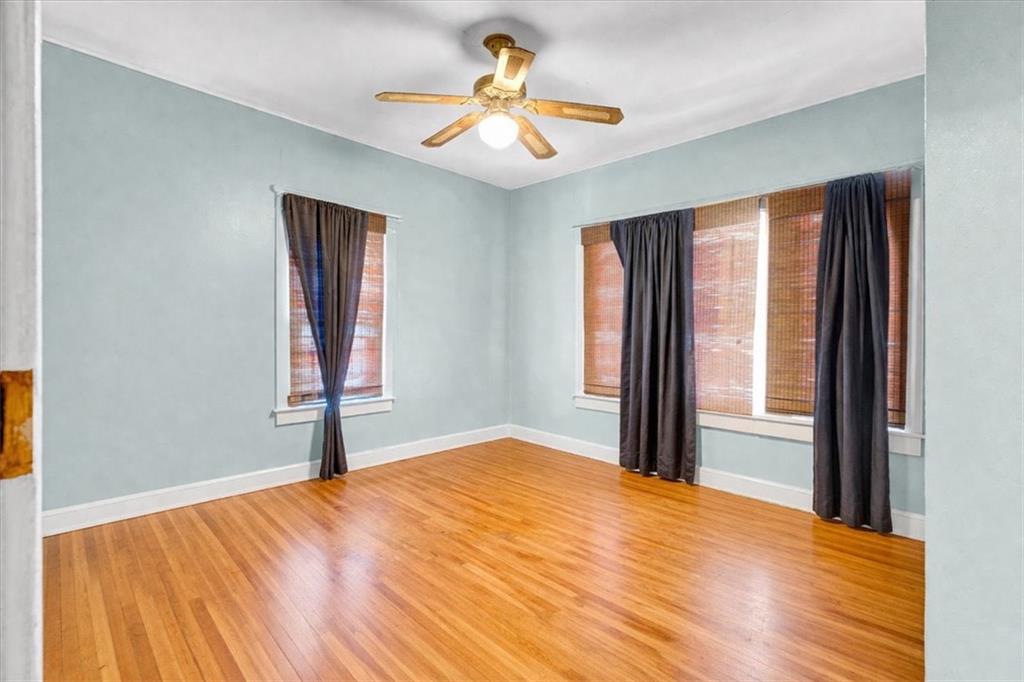 943 Washington Place Southwest Atlanta, GA 30314 - Photo 7 of 25 a bedroom with a bed and a chandelier