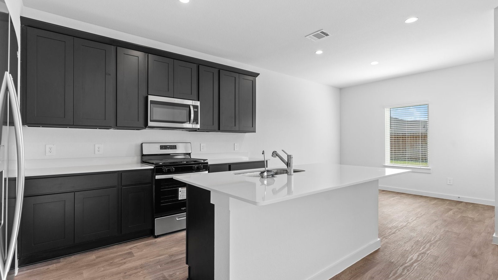6216 Orchid Crst Lane Rosenberg, TX 77469 - Photo 9 of 48 a kitchen with a sink and a stove top oven with wooden floor