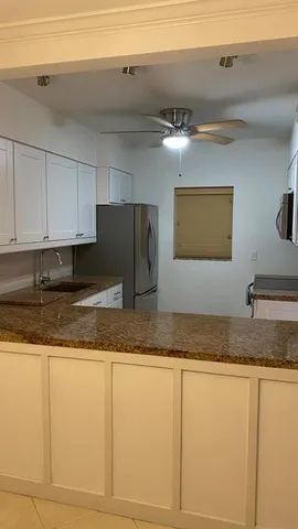 a view of a swimming pool and lounge chairs