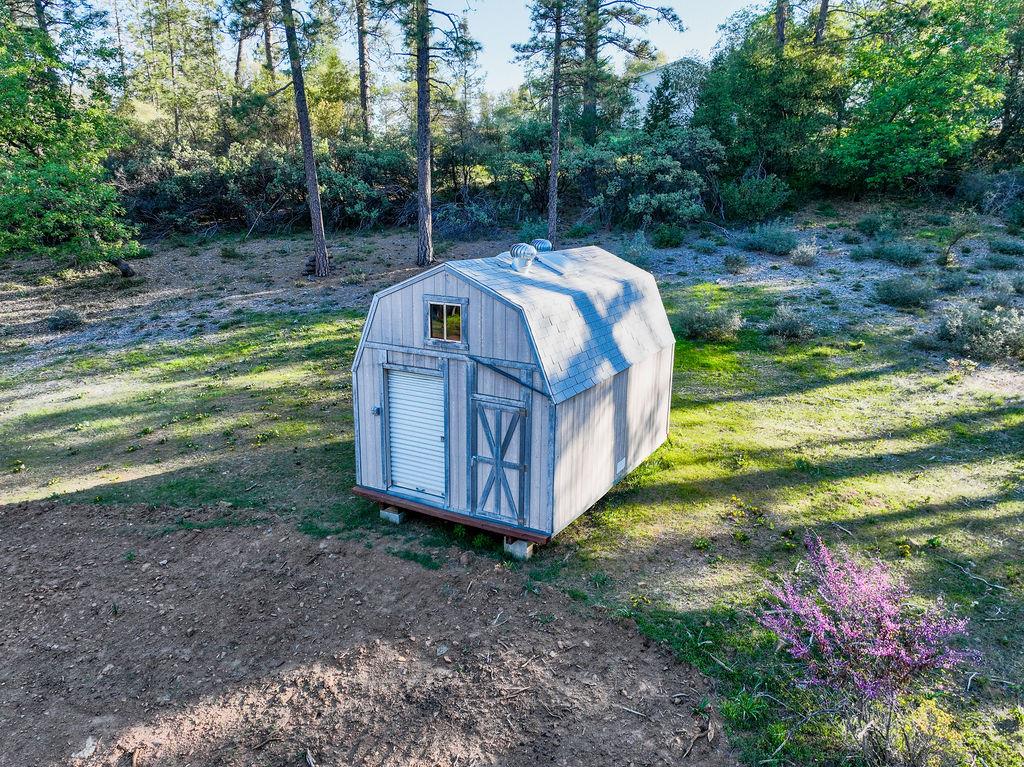 13279 Thoroughbred Loop Grass Valley, CA 95949 - Photo 6 of 33 a view of a yard with a tub and trees in the background