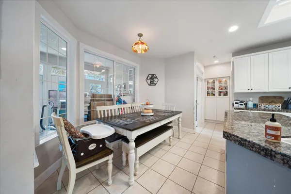 a kitchen with white cabinets and appliances