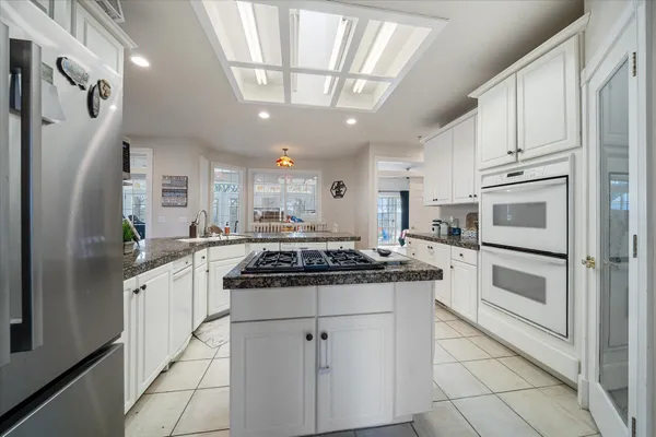 a kitchen with stainless steel appliances granite countertop a stove and a refrigerator