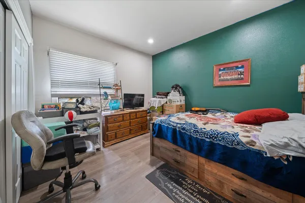 a bedroom with furniture and a window