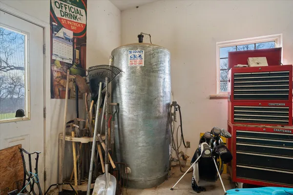 a view of an house with backyard and a tree