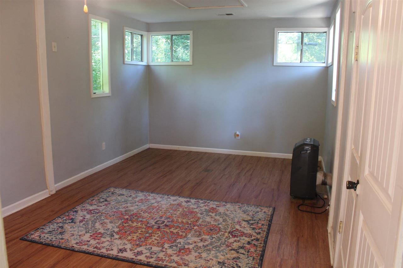 985 Little John Road Memphis, TN 38111 - Photo 13 of 24 wooden floor in an empty room with a window
