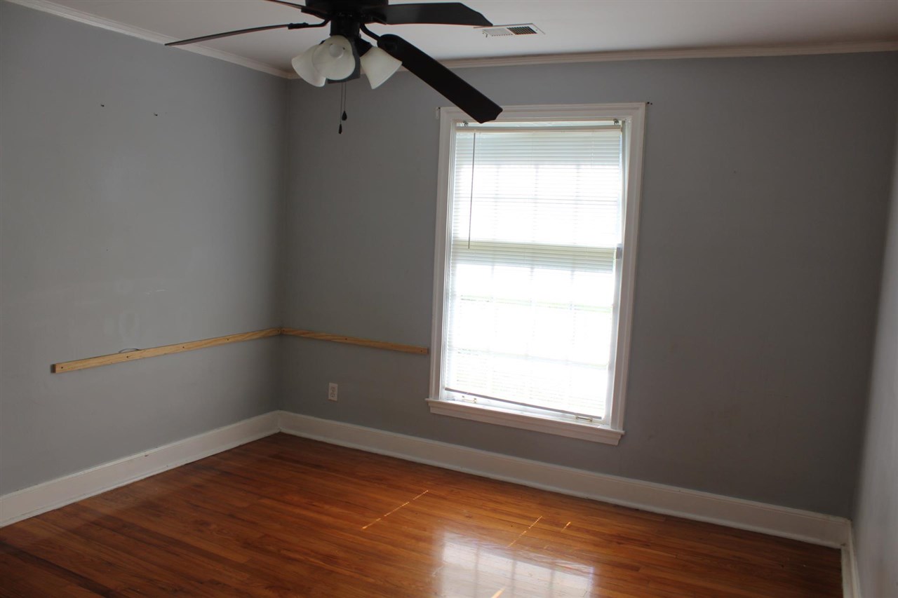 985 Little John Road Memphis, TN 38111 - Photo 15 of 24 a view of an empty room with wooden floor and a window