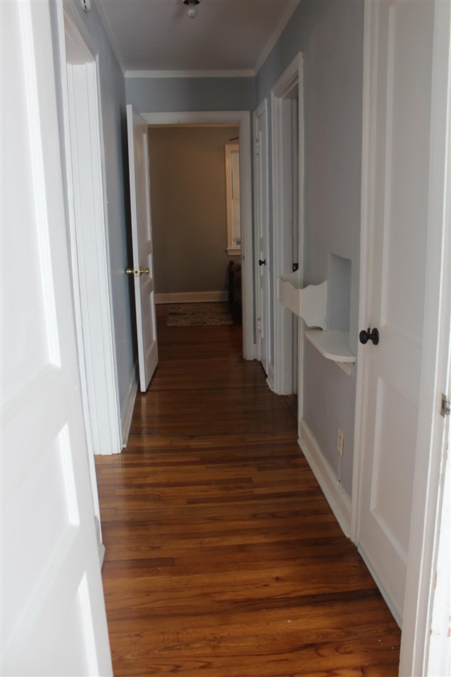 985 Little John Road Memphis, TN 38111 - Photo 17 of 24 a view of a hallway with wooden floor and staircase