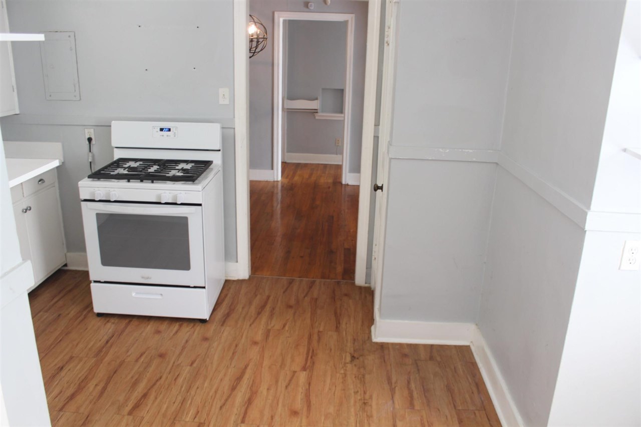 985 Little John Road Memphis, TN 38111 - Photo 6 of 24 a kitchen with a wooden floor and white stove