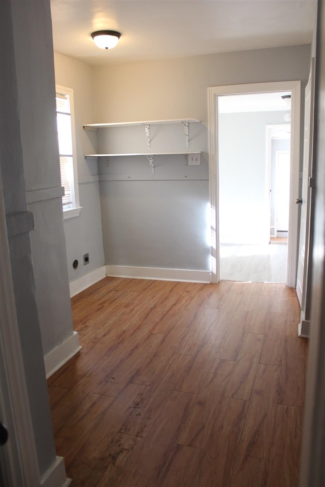 985 Little John Road Memphis, TN 38111 - Photo 7 of 24 an empty room with wooden floor cabinet and windows