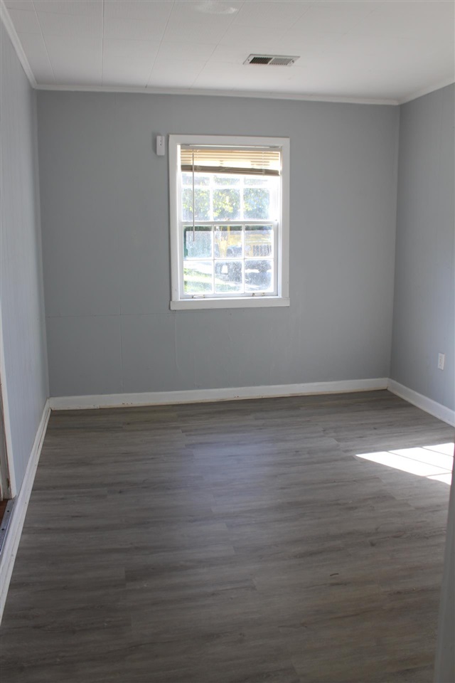 985 Little John Road Memphis, TN 38111 - Photo 8 of 24 a view of an empty room with wooden floor and a window