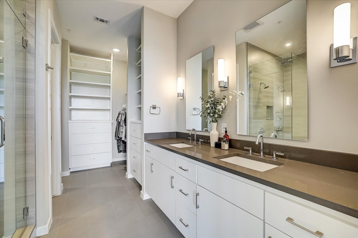 5921 Hiline Road, Unit 1204 Austin, TX 78734 - Photo 28 of 36 Bathroom with a stall shower, a spacious closet, double vanity, and dark tile patterned flooring