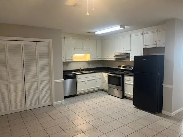 a kitchen with a cabinets and steel appliances