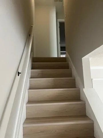 a view of staircase with white walls