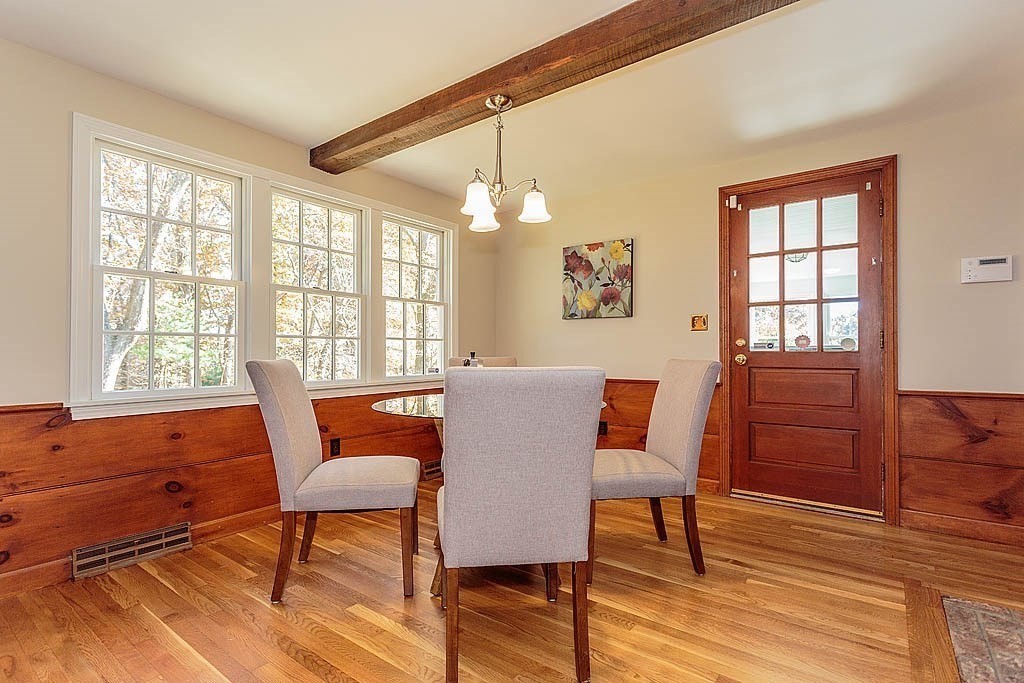 49 Amble Road Chelmsford, MA 01824 - Photo 8 of 26 a dining room with wooden floor a chandelier a glass table and chairs