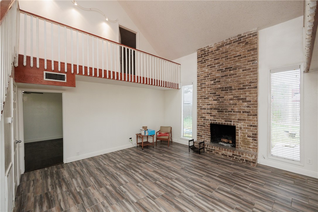 4029 Congressional Drive Corpus Christi, TX 78413 - Photo 11 of 34 a view of an empty room with wooden floor and a fireplace