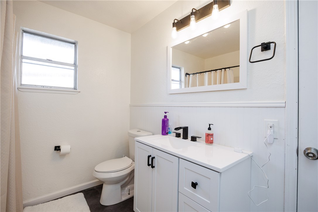 4029 Congressional Drive Corpus Christi, TX 78413 - Photo 19 of 34 a bathroom with a sink vanity mirror and toilet