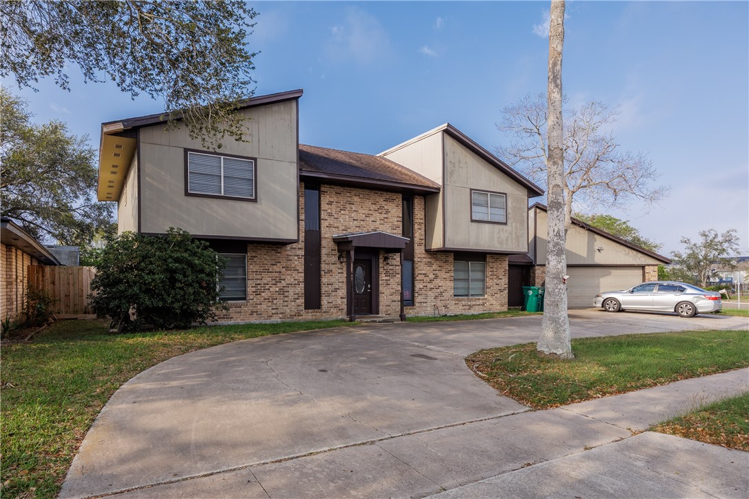 4029 Congressional Drive Corpus Christi, TX 78413 - Photo 2 of 34 a front view of a house with a yard and garage