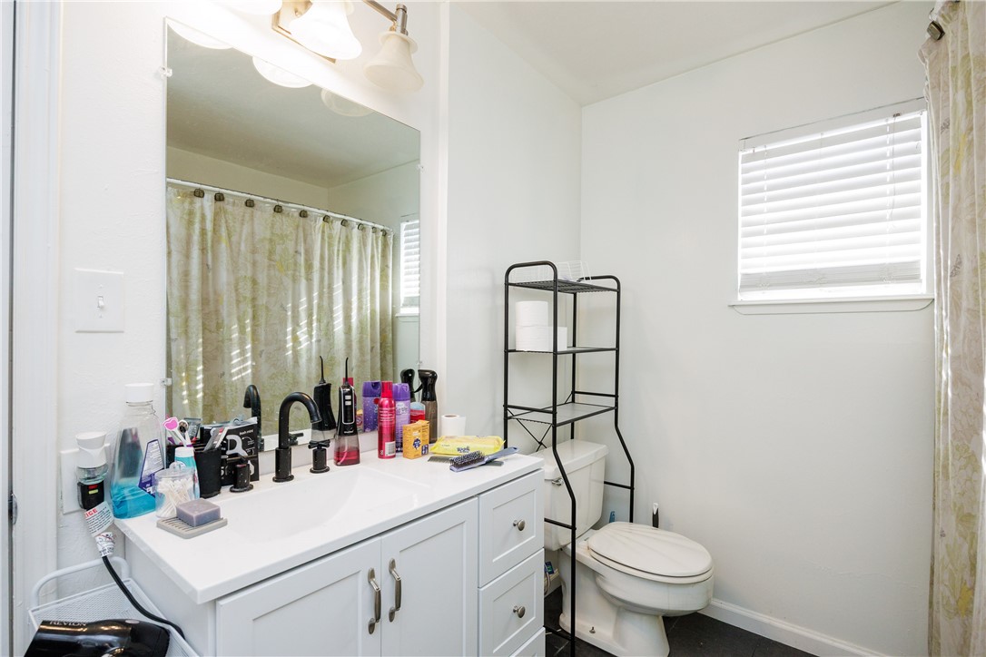 4029 Congressional Drive Corpus Christi, TX 78413 - Photo 23 of 34 a bathroom with a sink vanity mirror and toilet