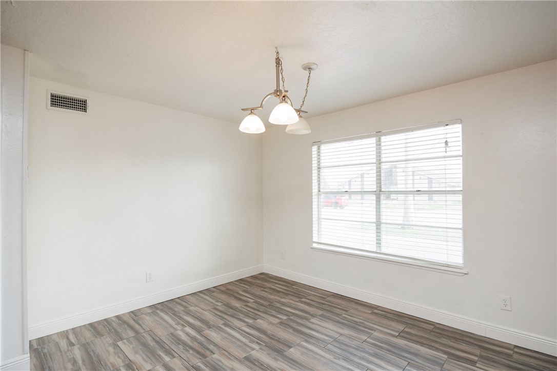4029 Congressional Drive Corpus Christi, TX 78413 - Photo 24 of 34 an empty room with wooden floor and windows