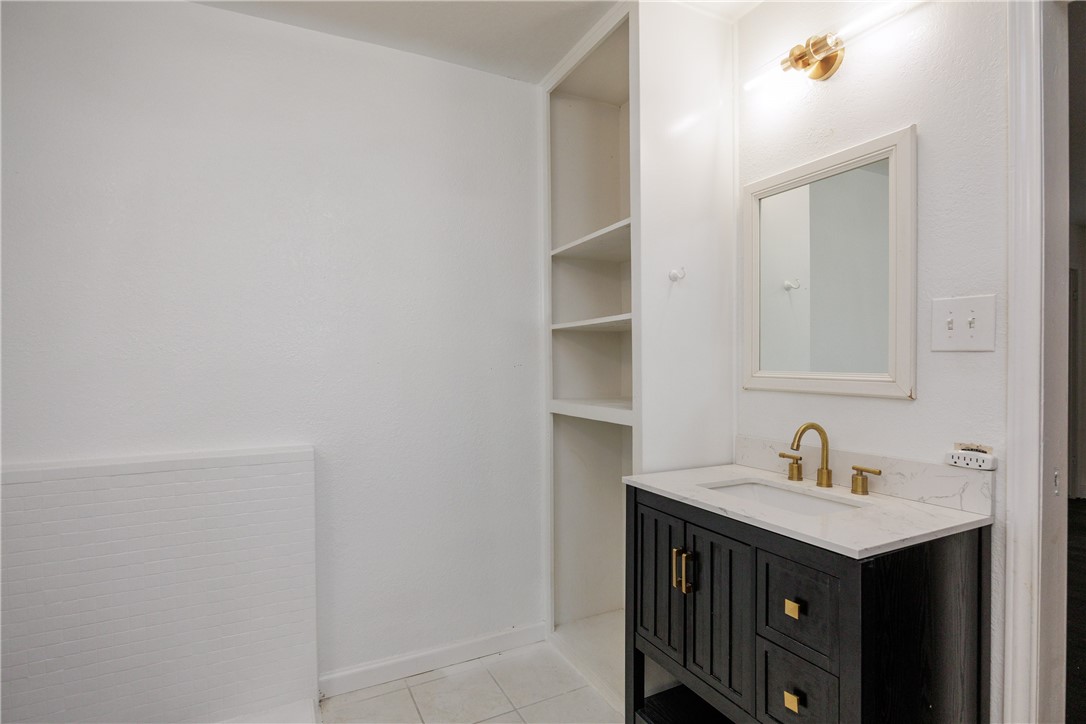 4029 Congressional Drive Corpus Christi, TX 78413 - Photo 32 of 34 a bathroom with a sink and a mirror