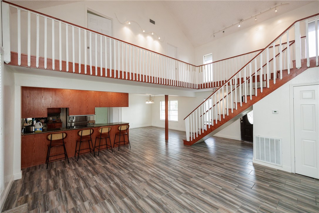 4029 Congressional Drive Corpus Christi, TX 78413 - Photo 4 of 34 a hallway with wooden floor table and chairs