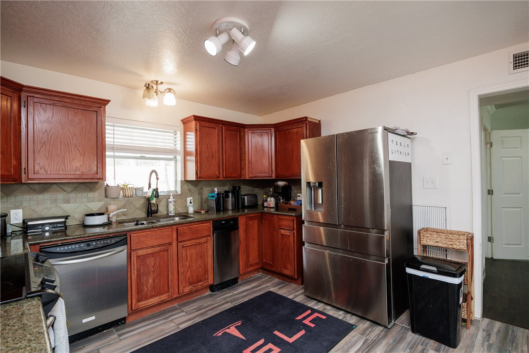 4029 Congressional Drive Corpus Christi, TX 78413 - Photo 7 of 34 a kitchen with stainless steel appliances granite countertop a refrigerator stove and sink