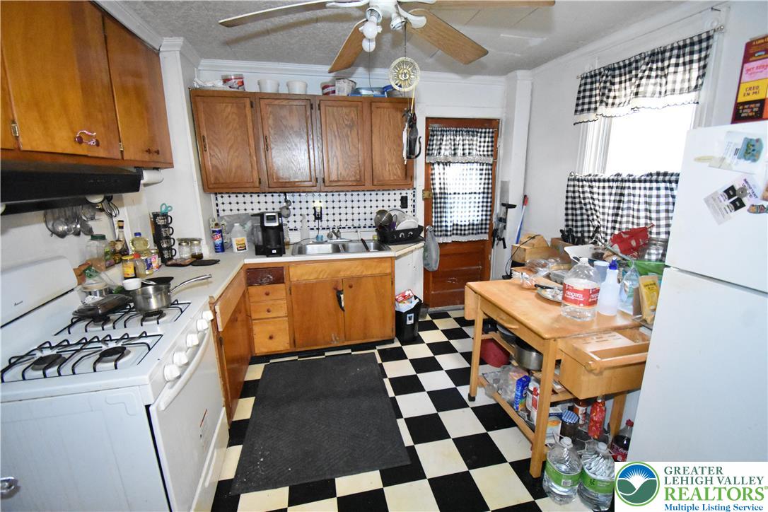 22 South Raspberry Street Easton, PA 18042 - Photo 4 of 16 a kitchen with a sink a stove a microwave and cabinets