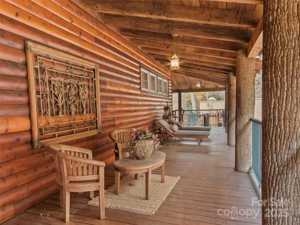 a balcony with chairs and wooden floor
