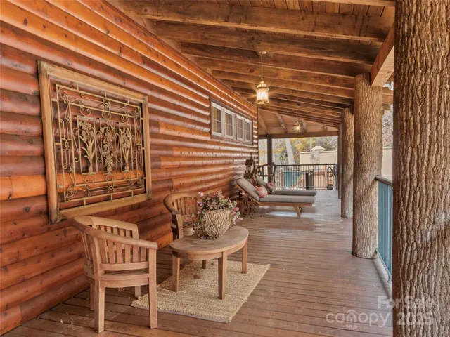 a balcony with chairs and wooden floor