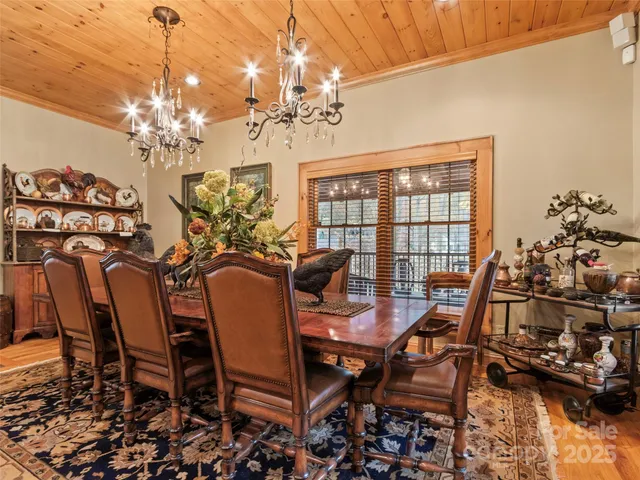 a view of a dining room with furniture and chandelier