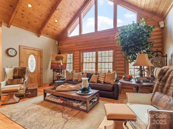 a living room with furniture a rug and a large window