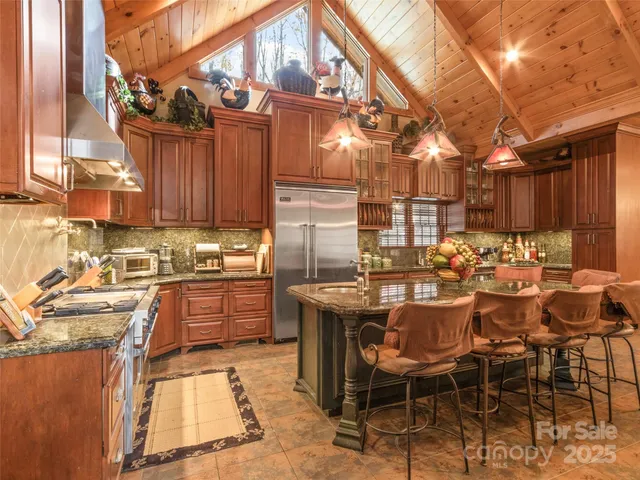 a kitchen with granite countertop lots of wooden cabinets a sink and dishwasher