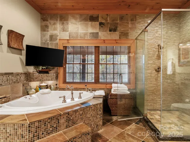 a bathroom with a tub sink and mirror