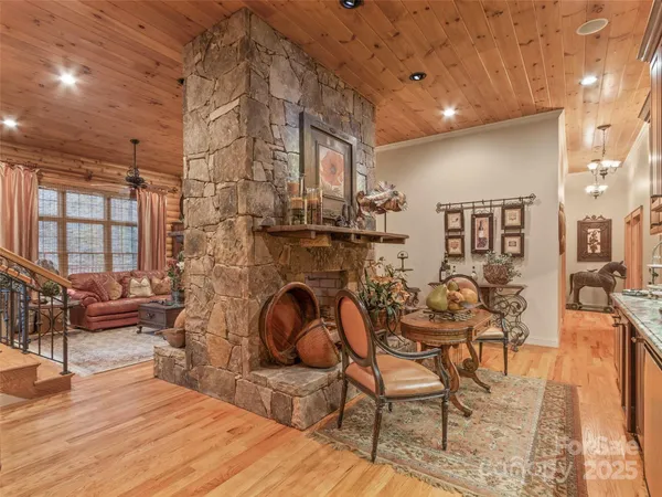 a living room with fireplace furniture and a wooden floor