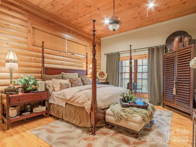 a bedroom with bed couch and window