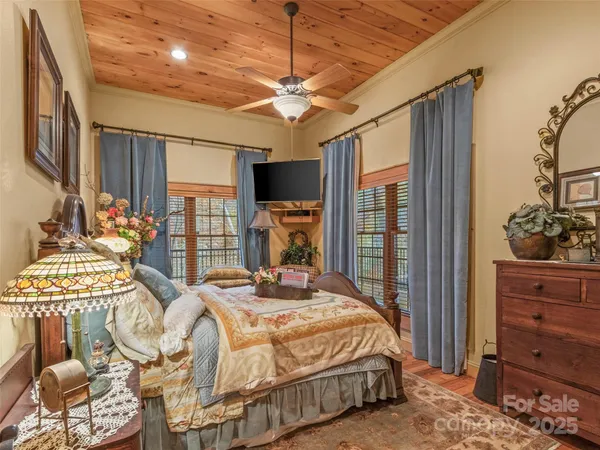 a bedroom with a bed and large mirror