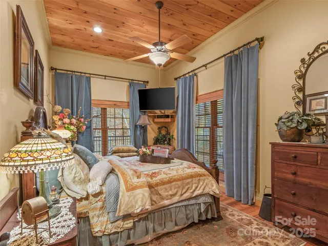 a bedroom with a bed and large mirror