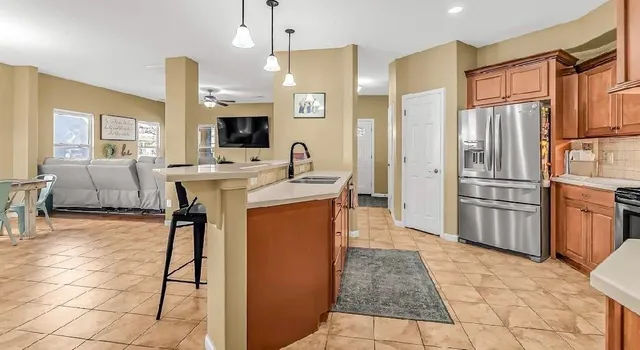 a kitchen with stainless steel appliances a refrigerator and a stove top oven