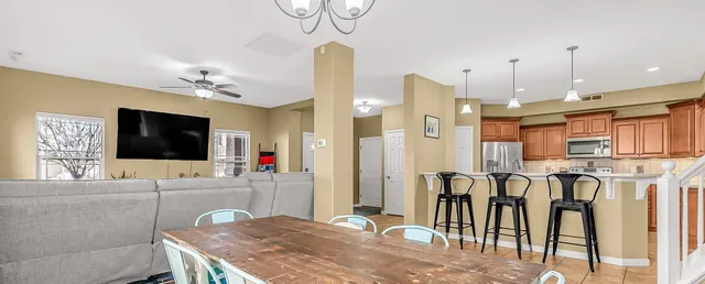 a living room with kitchen island furniture and a flat screen tv