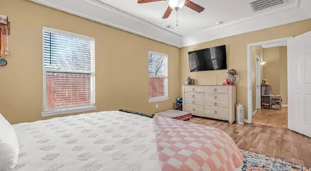 a bedroom with a large bed and flat tv