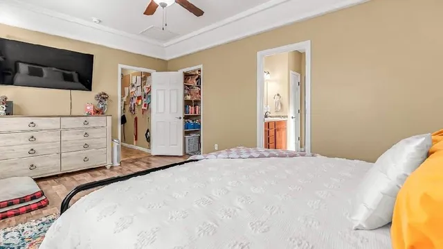 a bedroom with a bed and flat screen tv