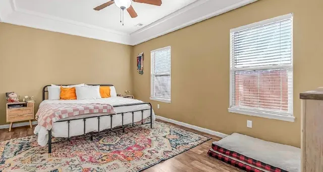 a bedroom with a bed dresser and a window