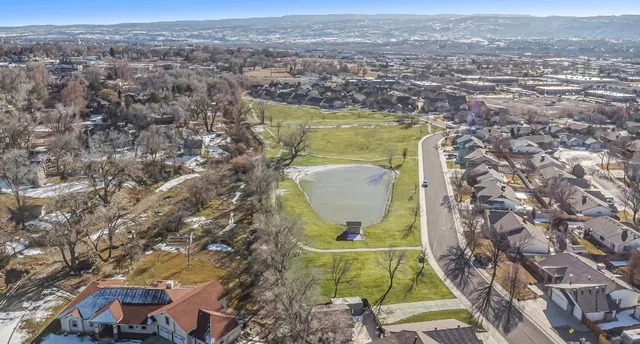 an aerial view of residential houses with yard